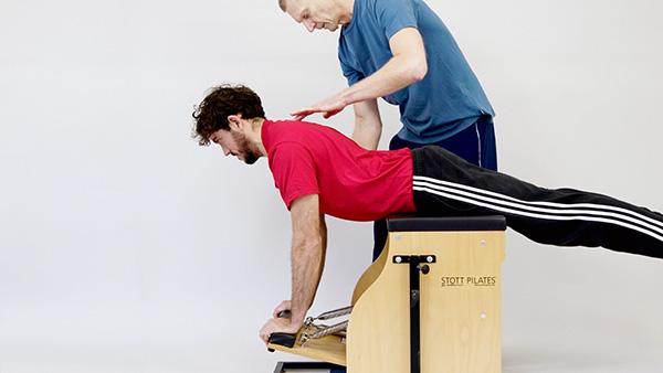 Equipment Pilates strengthening upper and lower-body exercises using Pilates stability chair in Stoke Newington